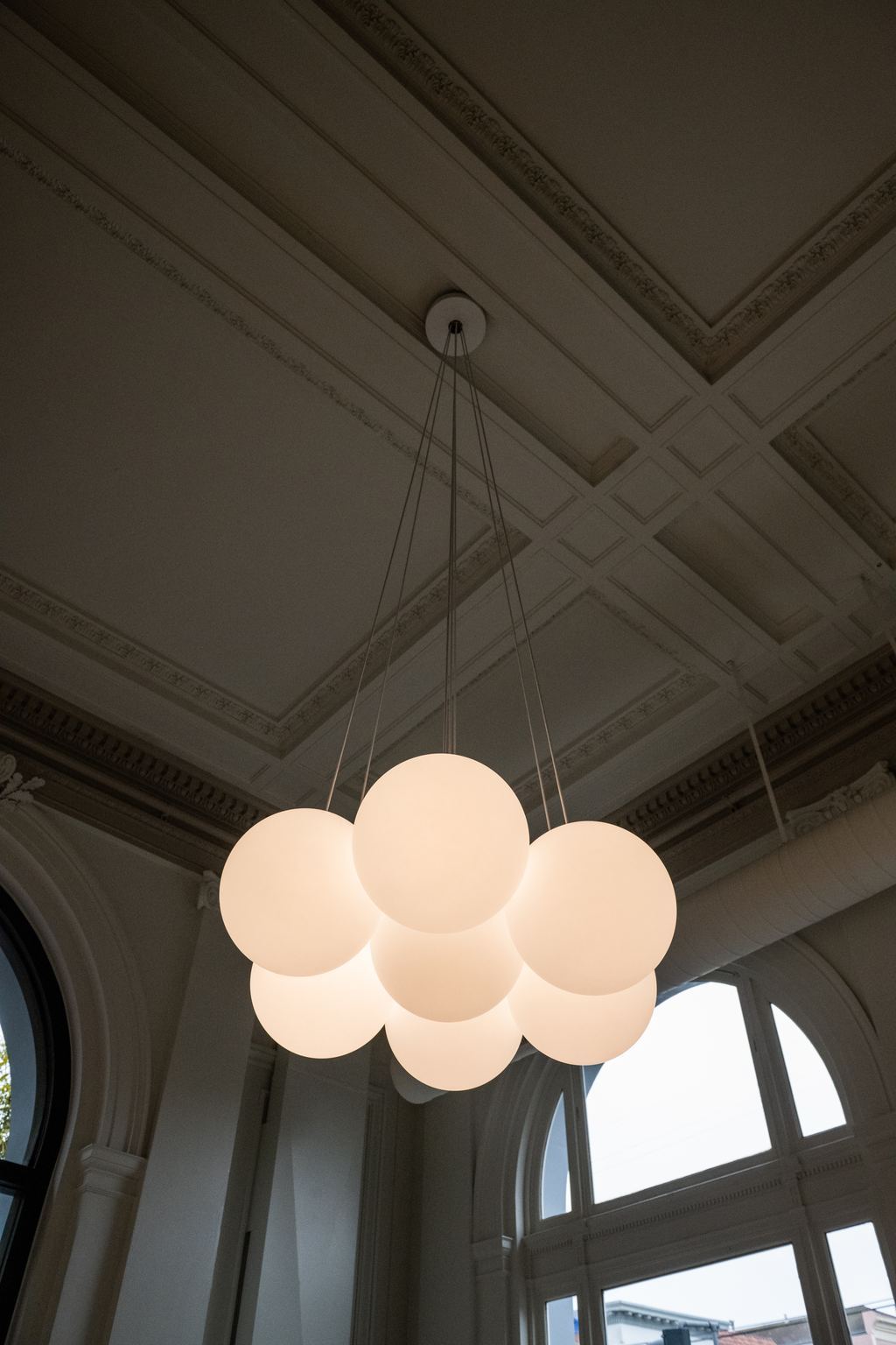Coffered plaster ceiling with a new globe pendant cluster