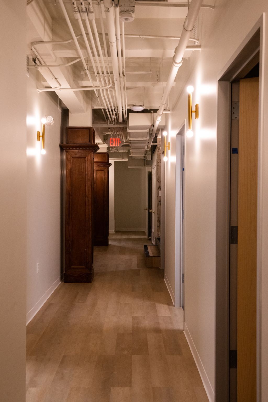 Corridor where original dark wood casings meet new finishes