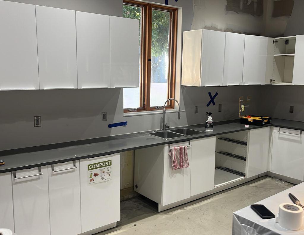 Break-room kitchen rebuilt with new cabinets after a water loss